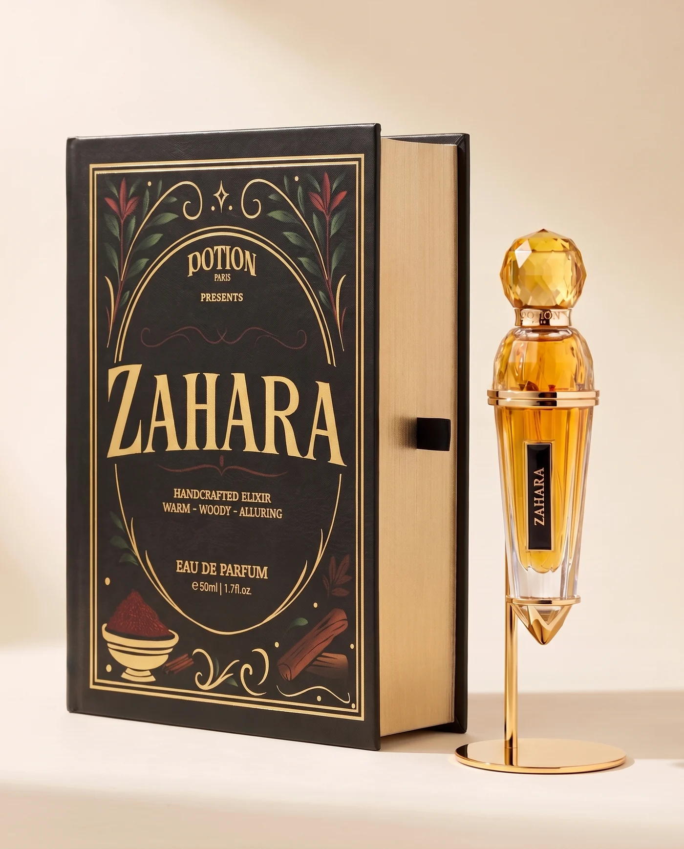The Zahara black and gold book-box beside its gold vial, on a cream ground.